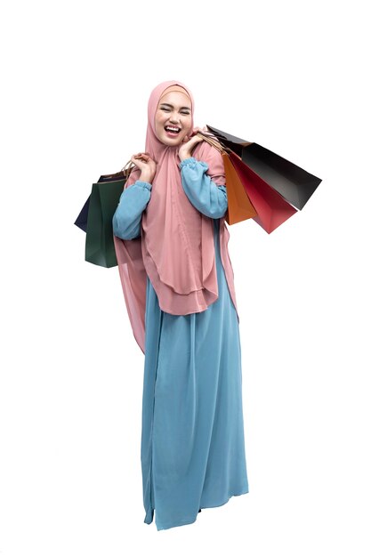 Asian Muslim woman in veil holding shopping bags