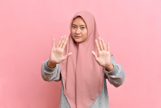 Asian Muslim woman Woman showing stop gesture