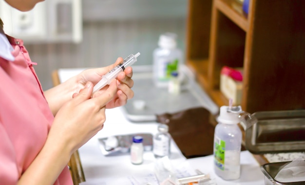 Asian nurses are preparing to syringe for injection patient in a hospital.