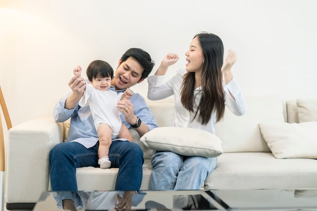 Asian Parents and a kid child playing at home. Family concept.