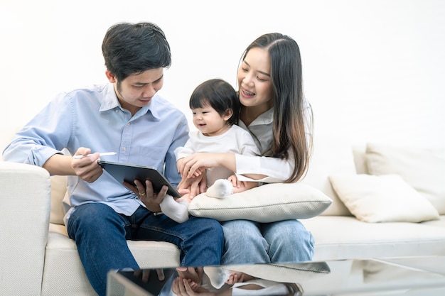 Asian Parents and a kid child playing at home. Family concept.