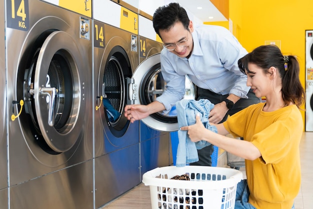 Asian people using qualified laundry machine in the public room