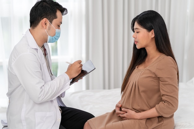 Asian pregnant woman visit gynecologist doctor at hospital for pregnancy consultant