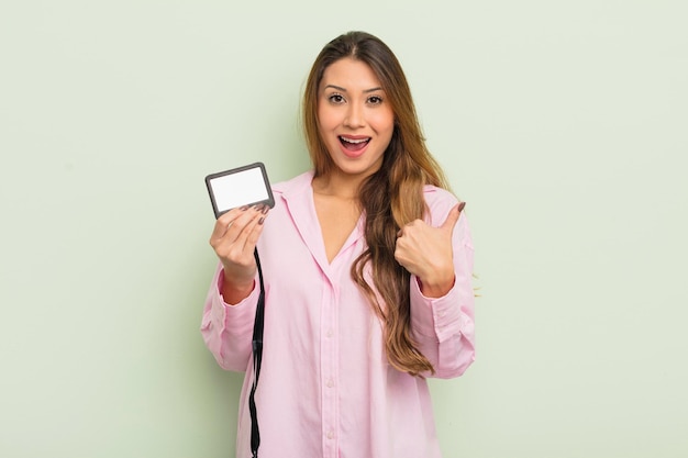 Asian pretty woman feeling happy and pointing to self with an excited pass card id concept