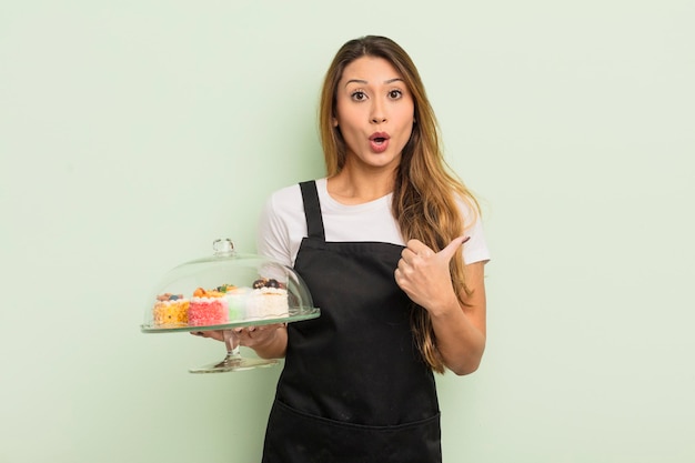 Asian pretty woman looking astonished in disbelief. home made cakes concept