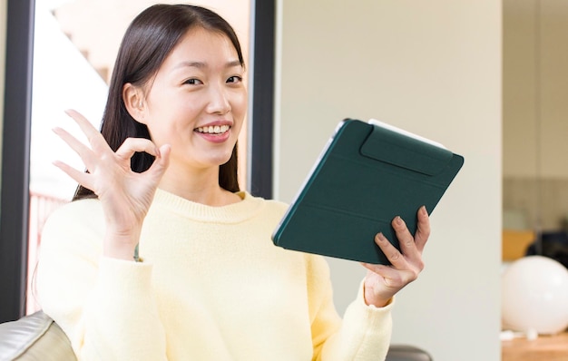 Asian pretty woman using a touchscreen pad