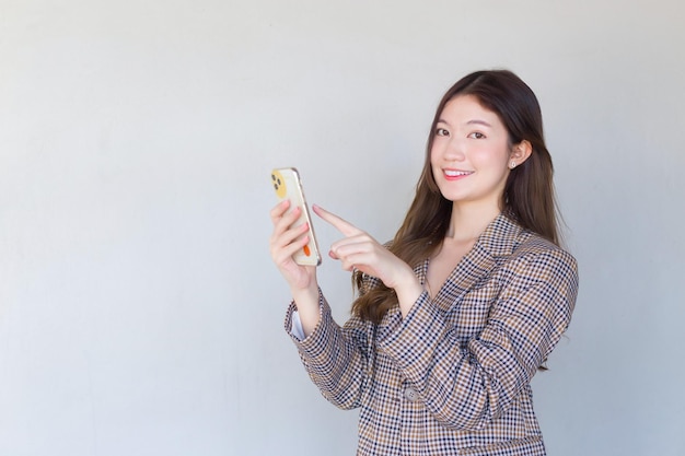 Asian professional Female with black long hair wearing plaid suit with success of work