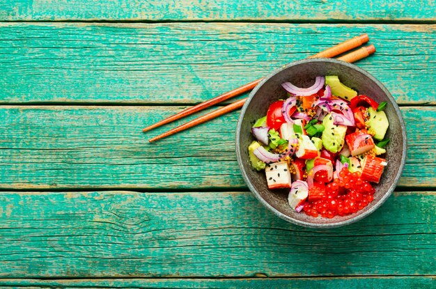 Asian salad of fish caviar,crab sticks and avocado