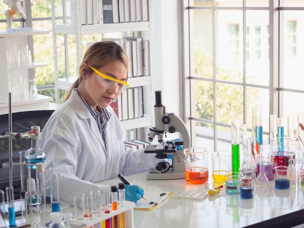 Asian scientist working in laboratory with microscope