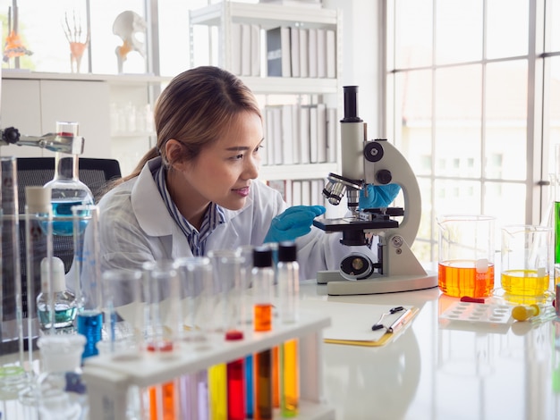 Asian scientist working in laboratory with microscope