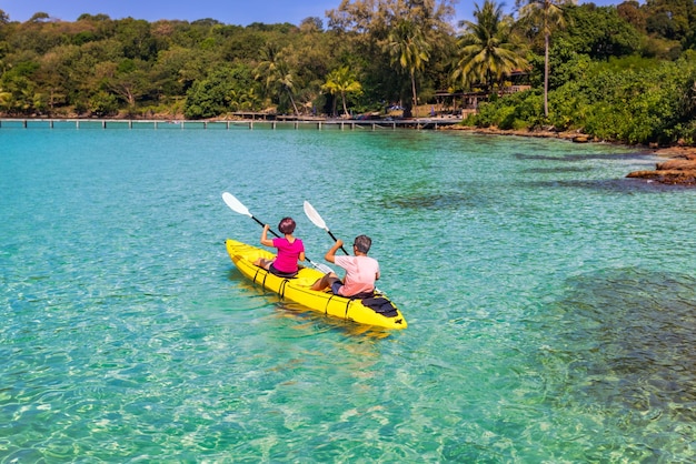 Asian senior couple on kayak in adventure travel in south east asia