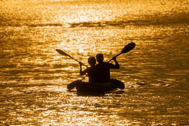 Asian senior couple on kayak in adventure travel in south east asia