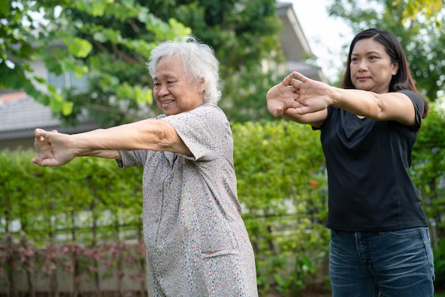 Asian senior or elderly old lady woman patient exercise with happy fresh enjoy in park healthy strong medical concept