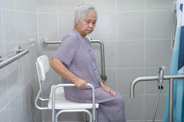 Asian senior or elderly old lady woman patient use toilet bathroom handle security in nursing hospital ward, healthy strong medical concept.