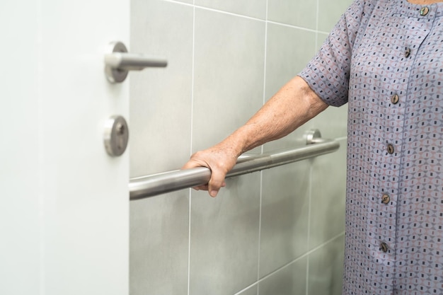 Asian senior or elderly old lady woman patient use toilet bathroom handle security in nursing hospital ward, healthy strong medical concept.