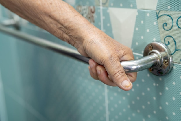 Asian senior or elderly old lady woman patient use toilet bathroom handle security in nursing hospital ward, healthy strong medical concept.