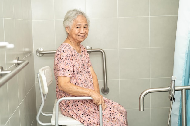 Asian senior or elderly old lady woman patient use toilet bathroom handle security in nursing hospital ward healthy strong medical concept