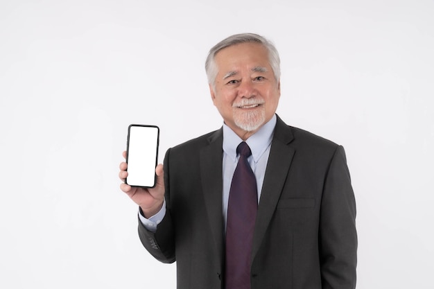 Asian senior man old man with suit feel happy good health showing smart phone with blank screen white screen isolated on white background Mock Up Image