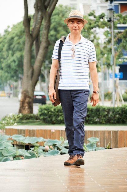 Asian senior man walking outdoors