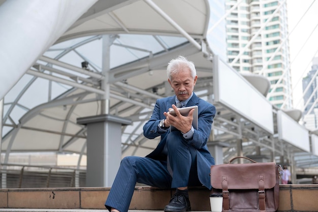 Asian senior mature middle aged businessman feeling worried and frustrated in modern city