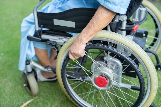 Asian senior woman patient on electric wheelchair at hospital healthy strong medical concept