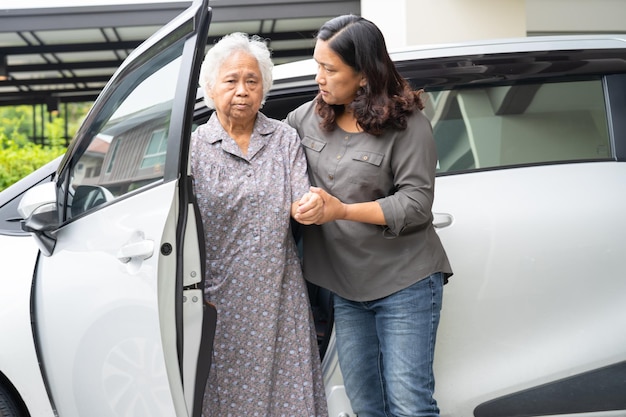 Asian senior woman patient sitting on walker prepare get to her car healthy strong medical