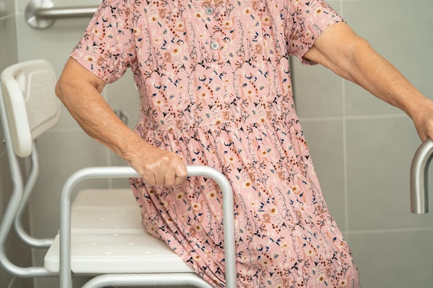 Asian senior woman patient use toilet bathroom handle security in nursing hospital healthy strong medical concept