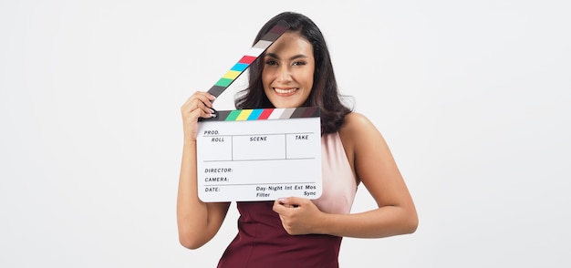 Asian sexy woman hold white clapper board or movie slate isolated on white background.She have tan skin ,show film,movies or cinema production concept.