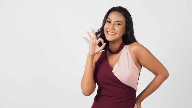 Asian sexy woman do a ok or okay hand sign on white backgroundshe has Tan skin or hazelnut skin tone