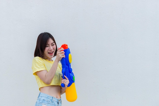 Asian sexy woman with water in hand on white backgroundFestival songkran day at thailandThe best of festival of thaiLand of smile