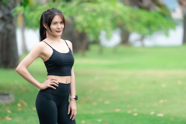 Asian slim woman exercise alone in the parkTired from workout