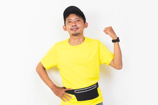 asian sporty man dressed in yellow tshirt showing strong gesture isolated on white background