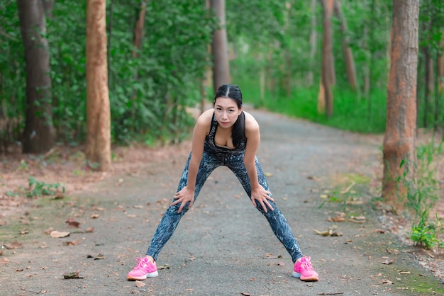 Asian sporty woman stretching body in the parkThailand people