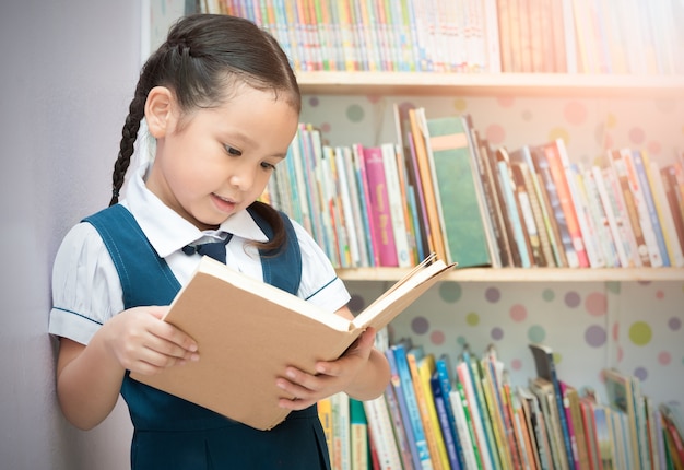 asian student cute girl reading book in  library 