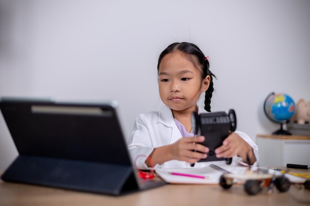 Asian students learn at home by coding robot cars and electronic board cables in STEM STEAM mathematics engineering science technology computer code in robotics for kids' concepts