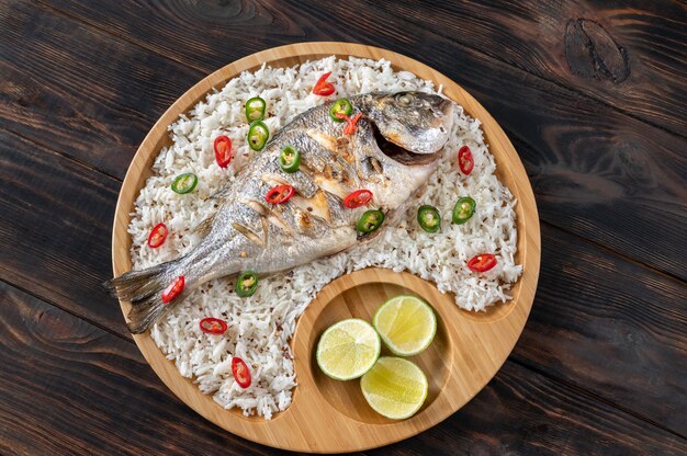 Asian-style grilled dorada garnished with white rice