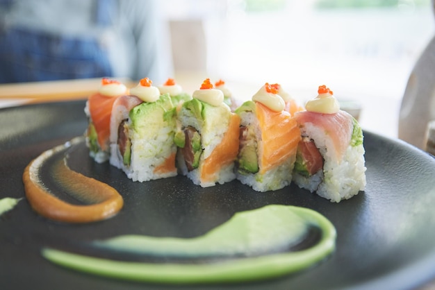 Asian sushi and plate of food at a restaurant for dinner or lunch meal at healthy Japanese cafe on table Plate cuisine and fine dining takeaway or seafood from a Salmon menu for diet or nutrition