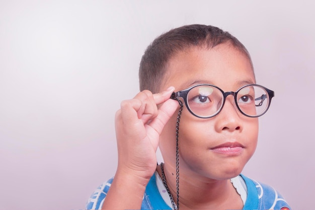 asian teenager holding nearsighted glasses. vision examination concept