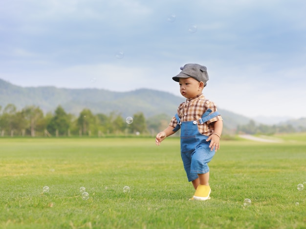 Asian toddler boy playing in nature park