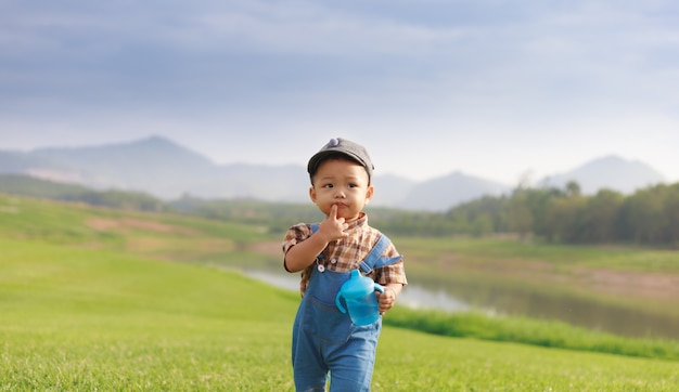 Asian toddler boy playing in nature park