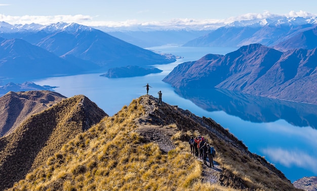 Asian tourists taking photo at Roy's Peak Lake Wanaka New Zealand