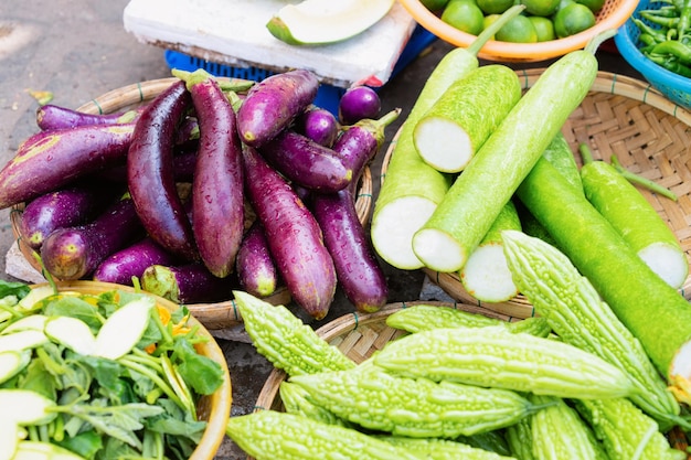 Asian vegetable assortment such as green bitter gourd and egg-plant on display in Hoi An in Vietnam in Asia. Variety of local stuff on Vietnamese street market.