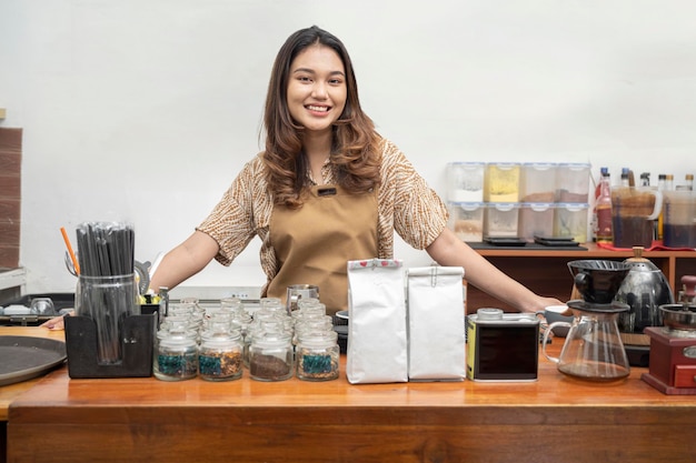 Asian woman baristas standing behind the counter