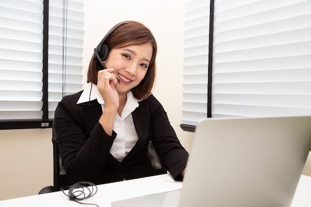 Asian woman call center with headphone.