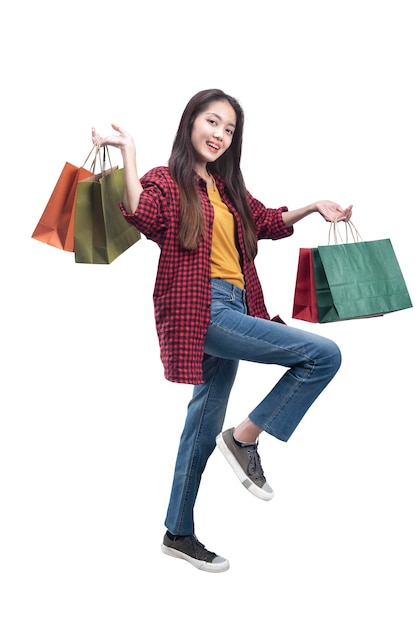 Asian woman carrying shopping bags isolated over white background