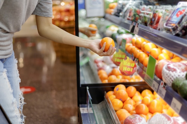 Asian woman in casual clothing shopping in supermarket