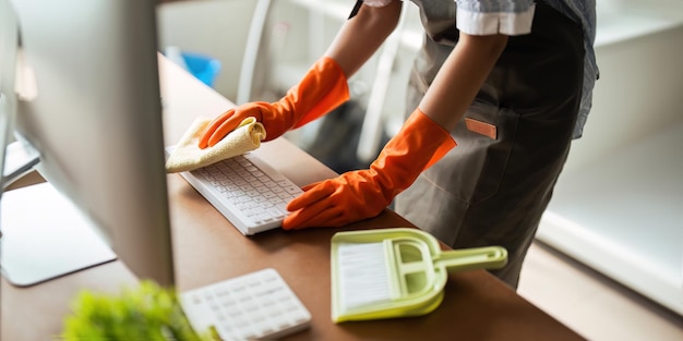 Asian woman cleaning in work room at home Young woman housekeeper cleaner use a cloth to wipe equipment for working concept housekeeping housework cleaning