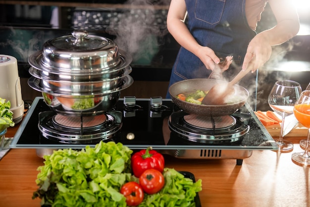 Asian woman cooking at kitchen her beautiful parents cooking together in kitchen at home