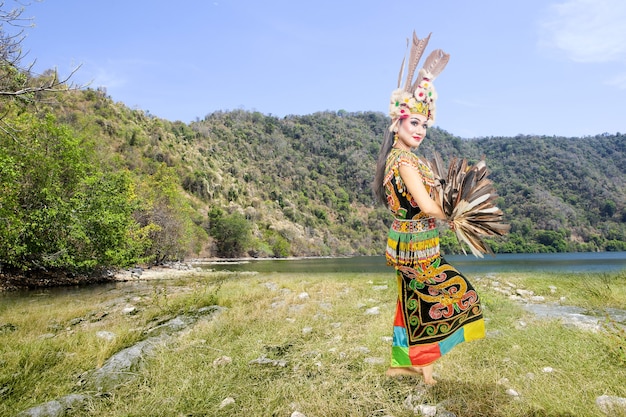 Asian woman dancing East Kalimantan traditional dance (Giring-Giring dance) at outdoor