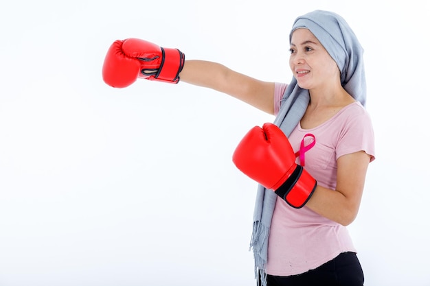 A asian woman disease mammary cancer patient fighting showing boxing gloves breast cancer awareness month isolated on white blank copy space studio backgroundhealthcaremedicine concept